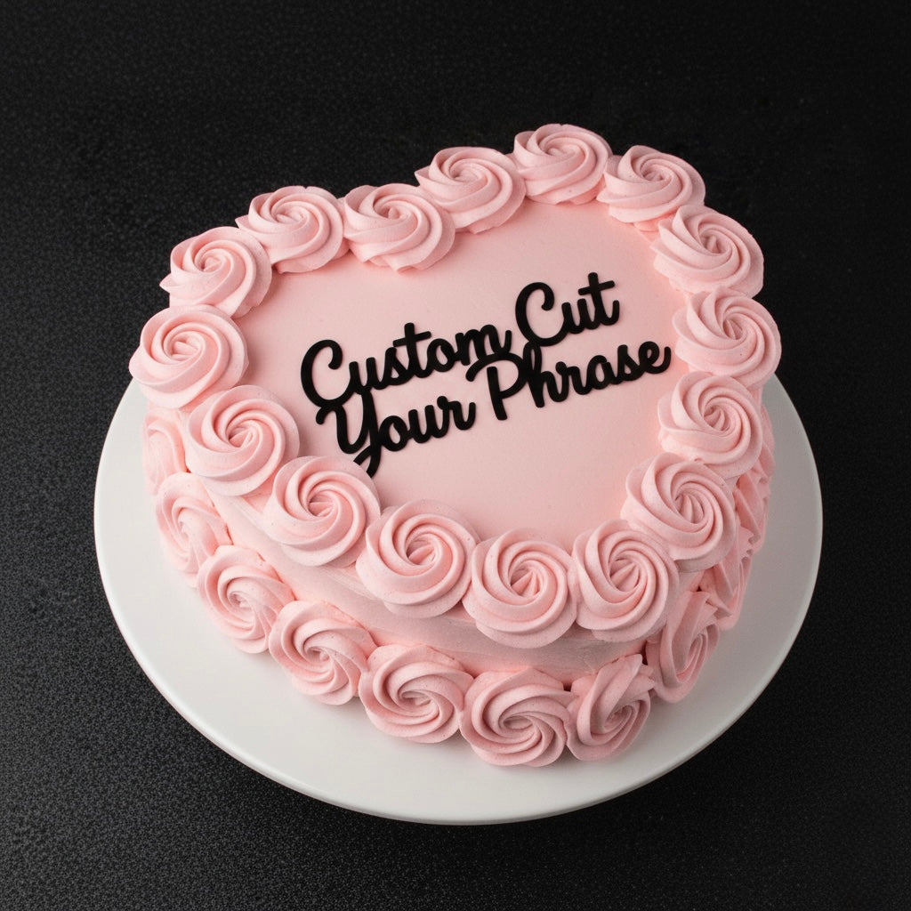 Pink frosted cake with 'Custom Cut Your Phrase' text on a black background