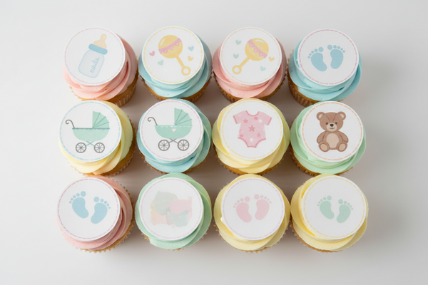 Cupcakes with baby-themed decorations on a white background