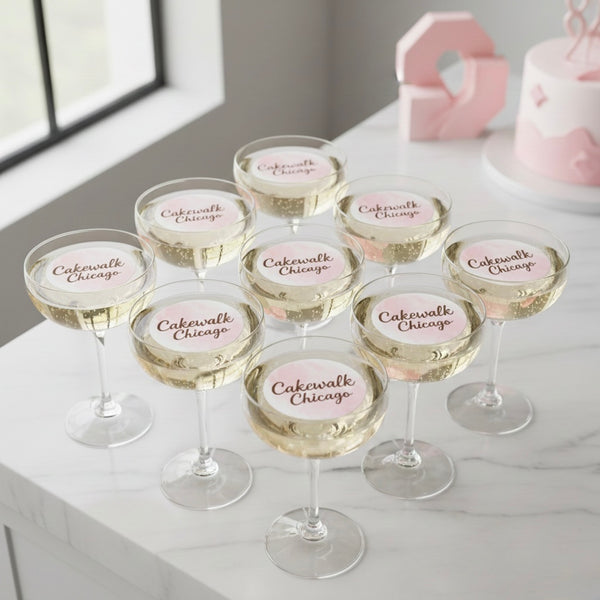 Set of champagne glasses with 'Cakewalk Chicago' label on a white surface.
