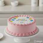 Video is of a round pink cake with pink piping that says Happy Birthday with a camera icon.  The video shows how a burn away cake topper works. The video plays a brown hand with a match burning the wafer paper to reveal a Black woman's face with a smile.