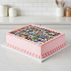 Square pink cake with photo collage on top in a kitchen setting